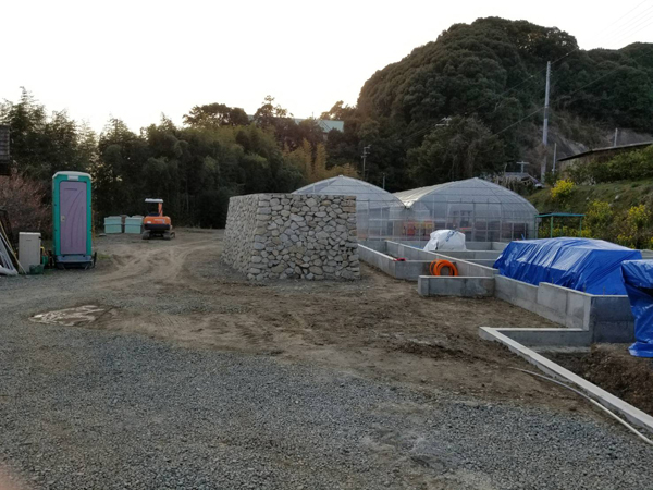 上芳養のコートハウス：完成した石塀と、その横に広がる建物の基礎